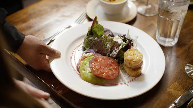 a plate of food beign served