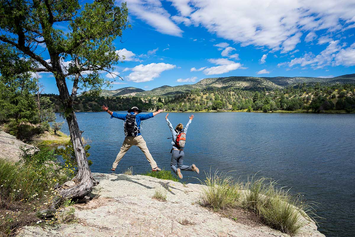 People leaping near mountain lake - Silver City, New Mexico