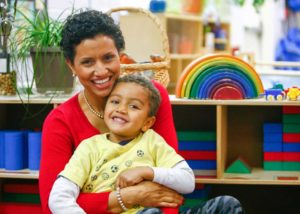 Woman in day care holding child