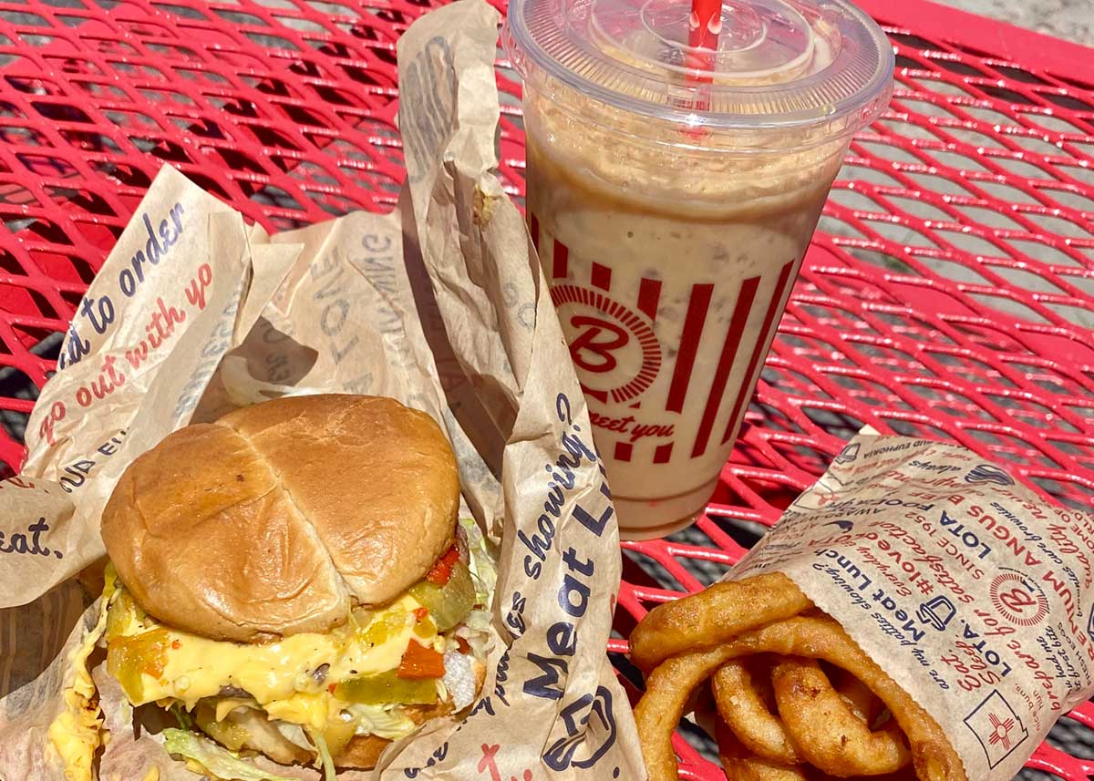 Blake's Lotaburger burger, onion rings, and beverage.