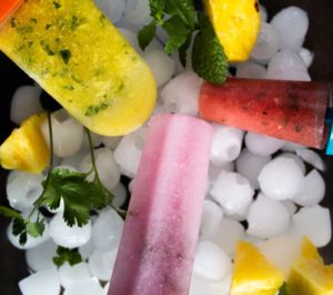 Homemade ice pops on a bed of ice.