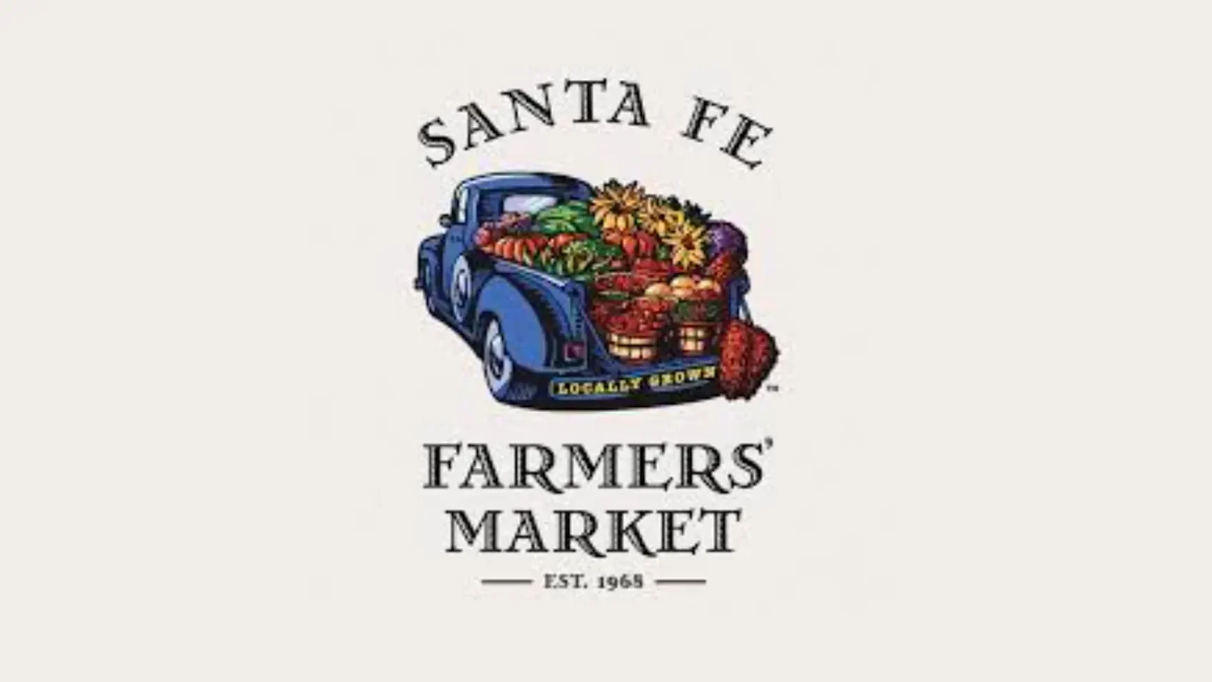 Santa Fe Farmers' Market logo featuring a blue vintage truck overflowing with fruits and vegetables, Est. 1965.