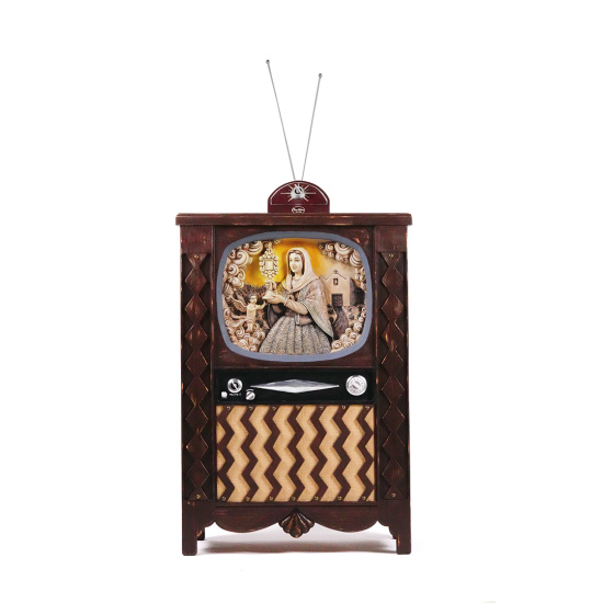 Vintage wooden television cabinet with two antenna rods; screen displays a painting of a woman serving food.